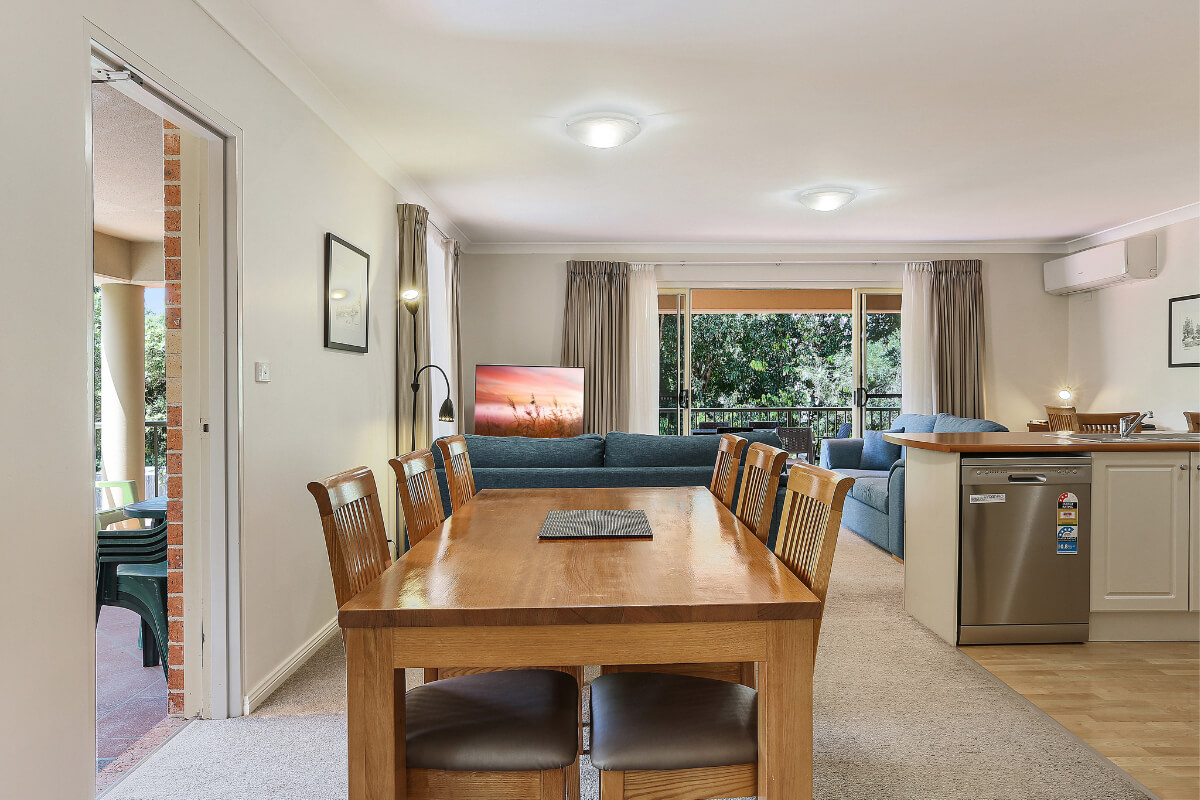 Spacious dining and living area in our two-bedroom poolside apartment